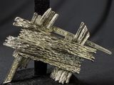 a close up of a metal object on a black surface
