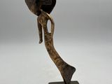 a bronze sculpture of an elephant with a hat on its head