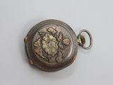 a silver pocket watch on a white surface