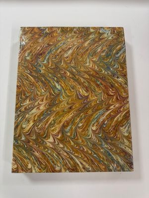 marbled paper on a white surface with a wooden frame