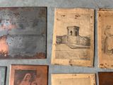 several old photos of people are displayed on a wall