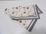 a white towel with a red flower on it