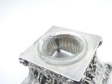 a silver candle holder on a white background