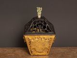 a black and gold box with a bird on top of it