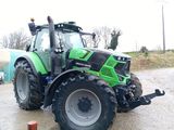 a green tractor that is parked on the side of the road