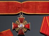 a red ribbon with a gold cross and a red ribbon with a gold cross and a red ribbon with a gold cross and a red ribbon with a gold