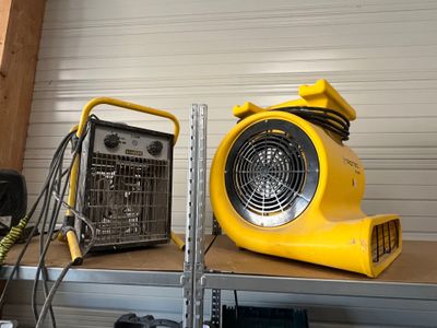 a yellow blower sitting on top of a shelf in a garage