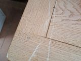 a close up of a wooden table with white paint on it