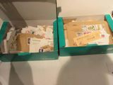 two boxes with mail inside of them on a table