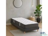 a bed with a mattress on top of it in a room