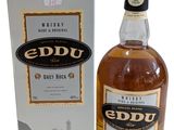 a bottle of eddu irish whiskey next to a box