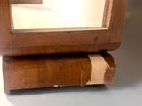 a mirror that is sitting on top of a wooden stand