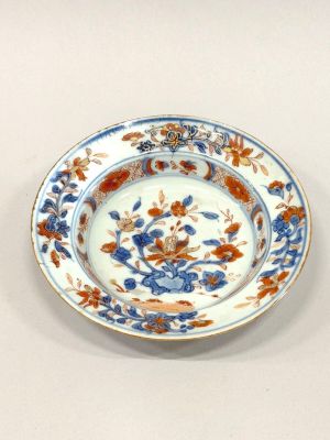 a blue and orange plate with flowers on it