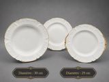 set of four white and gold dinner plates with gold trim