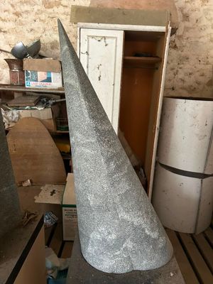 concrete cone sitting on top of a table next to a refrigerator