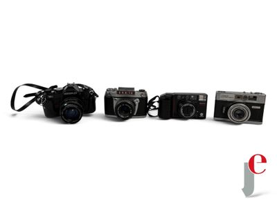 several cameras are lined up in a row on a white surface