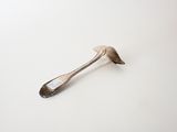 a spoon and a spoon rest on a white surface