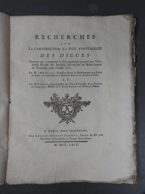 an old book that is open on a table
