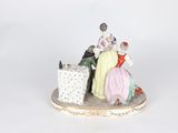a figurine of a woman and a man sitting on top of a box
