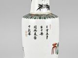a white vase with asian writing on it sitting on a table