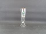 a tall glass with a green star on it