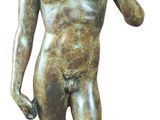 bronze statue of a young boy holding a bird