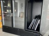 an image of a glass doored refrigerator in a room