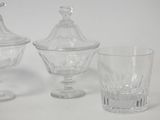 three glass dishes and a glass cup on the table