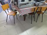 a table with a bunch of chairs and a computer on it