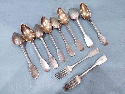 six silver spoons and six forks are arranged in a row