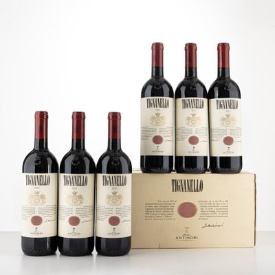 six bouteilles de vin dans un carton sur une table