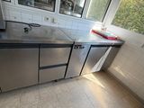 a kitchen with stainless steel cabinets and a microwave on the counter