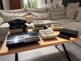 a coffee table that has a bunch of nintendo game consoles on it