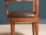 an image of a wooden chair with a brown leather seat