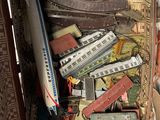 a box full of toy trains sitting on a bed
