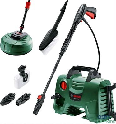 un nettoyeur haute pression électrique vert et noir, équipé d'un tuyau, d'une brosse et d'autres accessoires