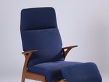 an image of a blue chair and ottoman in a white room