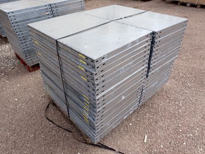 several stacks of steel plates stacked on top of each other in a warehouse