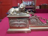 une statue de lion attachée par une chaîne posée sur une table