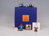 a blue box with figurines of people on top of it