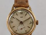 a close up of a wrist watch with a brown leather strap