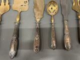 five different types of silverware on display on a table