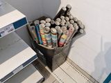 many cans of paint on the shelves in the store