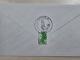 an envelope with a stamp on it sitting on a table