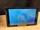 a close up of a tablet on a table with a clock on the screen