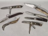 many different types of knives on a white surface
