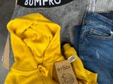 a box of clothing and a pair of jeans sitting on a table