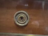 a wooden drawer with a brass knob on it