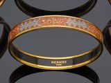 several different colored bracelets on a black surface with a black background