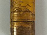 a small glass container with a wooden handle on a string
